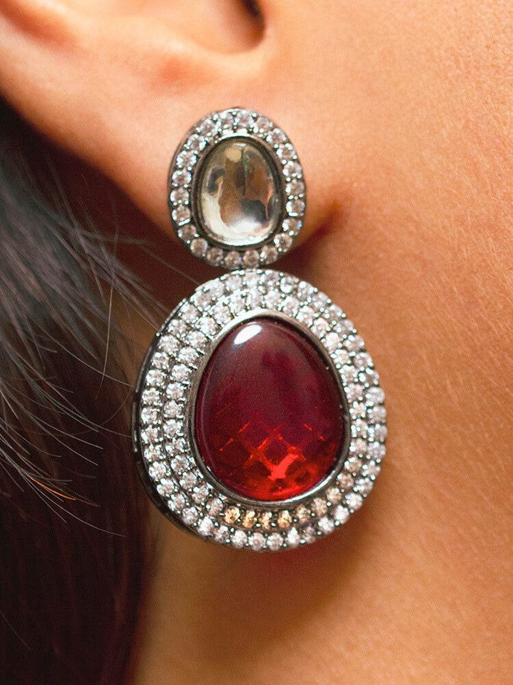 Close-up of a woman wearing a sparkling artificial diamond necklace with red colored stone and diamond earrings set, designed to offer a radiant, elegant look for any formal occasion or Indian wedding. This affordable diamond jewelry provides a flawless, luxurious alternative to natural diamonds.
