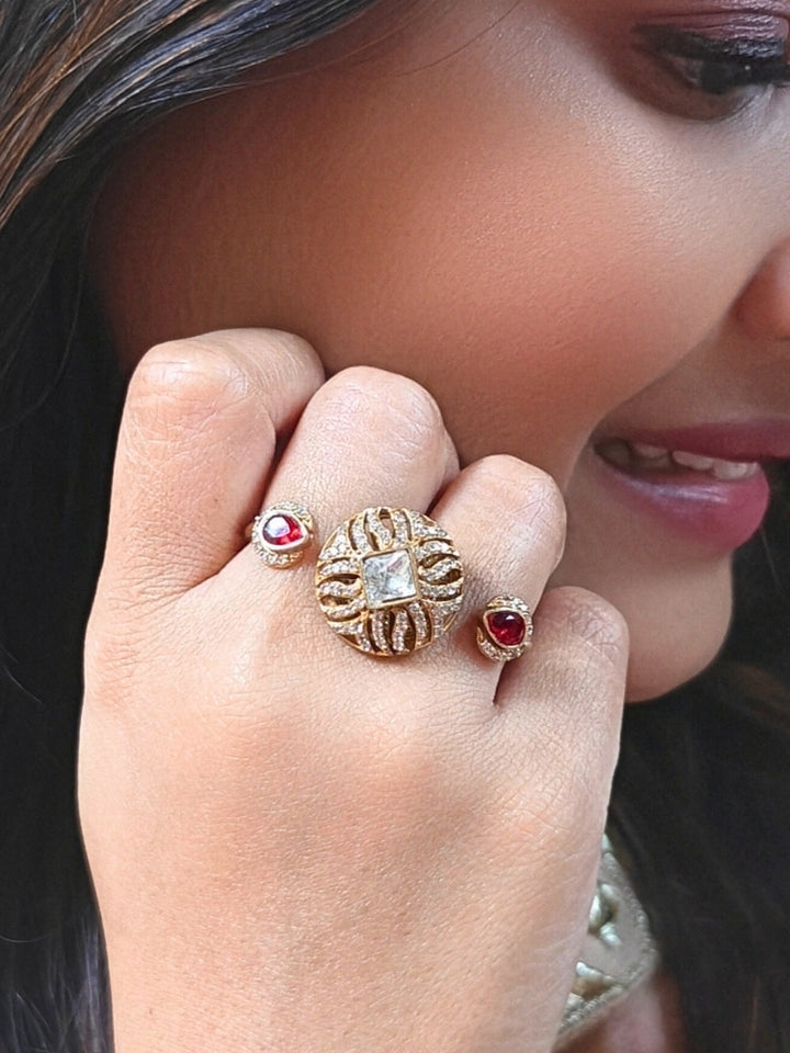Close-up of a woman wearing an ornate Indo-Western (Mehendi Gold Polish Antique Finish) Red Diamond Ring with American Diamond, Colored Stones and Mozanite. Elegant festive look with a high-quality imitation American diamond Ring. Indo-western outfit styled with a statement American diamond Ring.