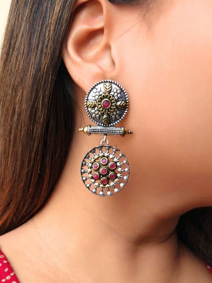 Close-up of a woman wearing an ornate traditional (Dual Tone Polish) Red Oxidised Earrings set with Kundan. Festive celebration look enhanced with sparkling artificial Oxidised Earrings. Saree look completed with elegant artificial Earrings set for festive occasions.