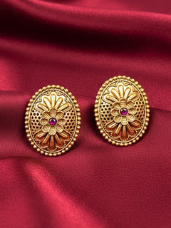 Close-up of an ornate traditional (Gold Polish) Studs Earrings with Filigree Work and Colored Stone. Festive Diwali outfit paired with a colorful Colored Stone Earrings. Festive celebration look enhanced with traditional Colored Stone Earrings.
