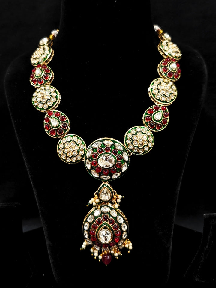 Close-up of an ornate traditional Red Jewelry Set, Earrings and Mangtikka with Kundan and Colored Stones. Bride wearing a traditional Kundan artificial necklace set for her wedding ceremony. A trending Kundan artificial jewelry for wedding season in India.