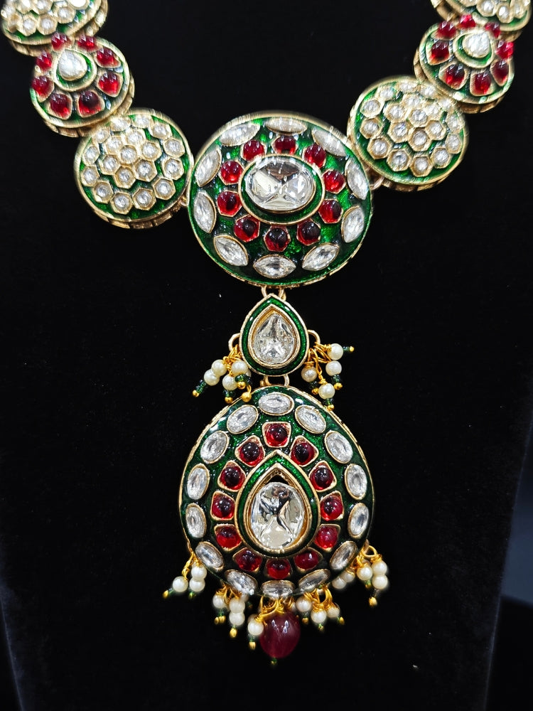 Close-up of an ornate traditional Red Jewelry Set, Earrings and Mangtikka with Kundan and Colored Stones. Bride wearing a traditional Kundan artificial necklace set for her wedding ceremony. A trending Kundan artificial jewelry for wedding season in India.