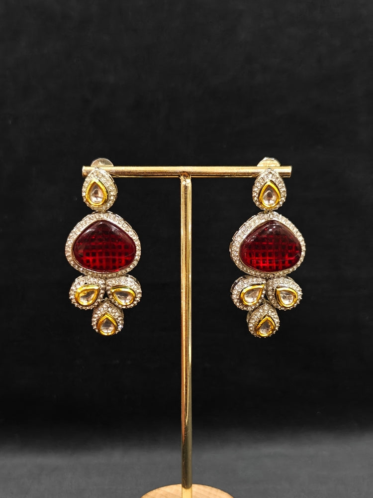 Close-up of a woman wearing an ornate traditional Red Collar Kundan jewellery set and earrings with American diamonds, Monalisa stone, Pearls, Kundan and Colored Stones. Festive Diwali outfit paired with a premium Kundan jewelry piece. Woman wearing trending Kundan artificial jewelry for wedding season in India.
