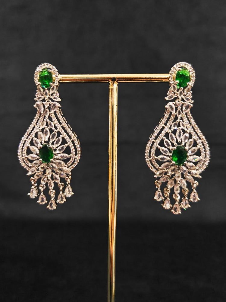 Close-up of an ornate Western Silver Diamond Collar jewellery set, earrings and Mangtikka with American Diamond and Green Color Stone. Bride-to-be styled in a premium American diamond artificial necklace for her reception party.
Close-up of a cocktail party look featuring a premium American diamond necklace.