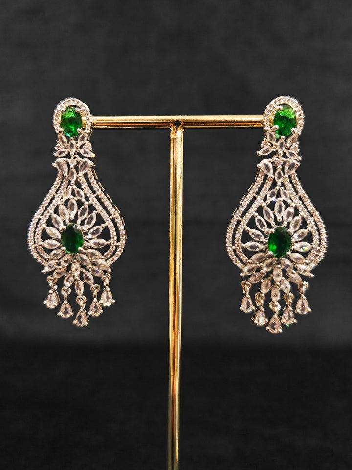 Close-up of an ornate Western Silver Diamond Collar jewellery set, earrings and Mangtikka with American Diamond and Green Color Stone. Bride-to-be styled in a premium American diamond artificial necklace for her reception party.
Close-up of a cocktail party look featuring a premium American diamond necklace.