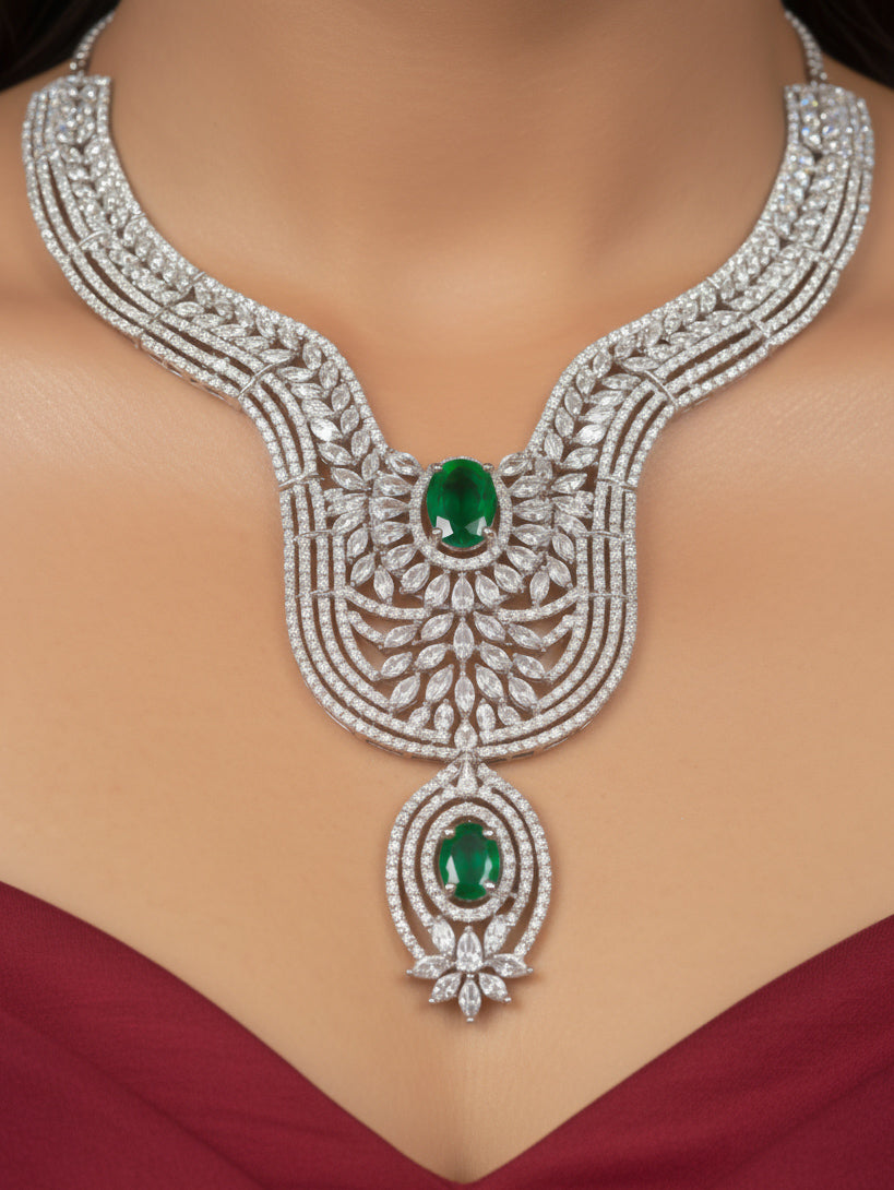 "Close-up of a model in luxurious artificial diamond jewelry featuring a designer diamond and green colored stone necklace and earrings with maangtikka set, crafted for bridal fashion and high-end weddings. This beautiful diamond jewelry set offers the brilliance of real diamonds at an affordable price."