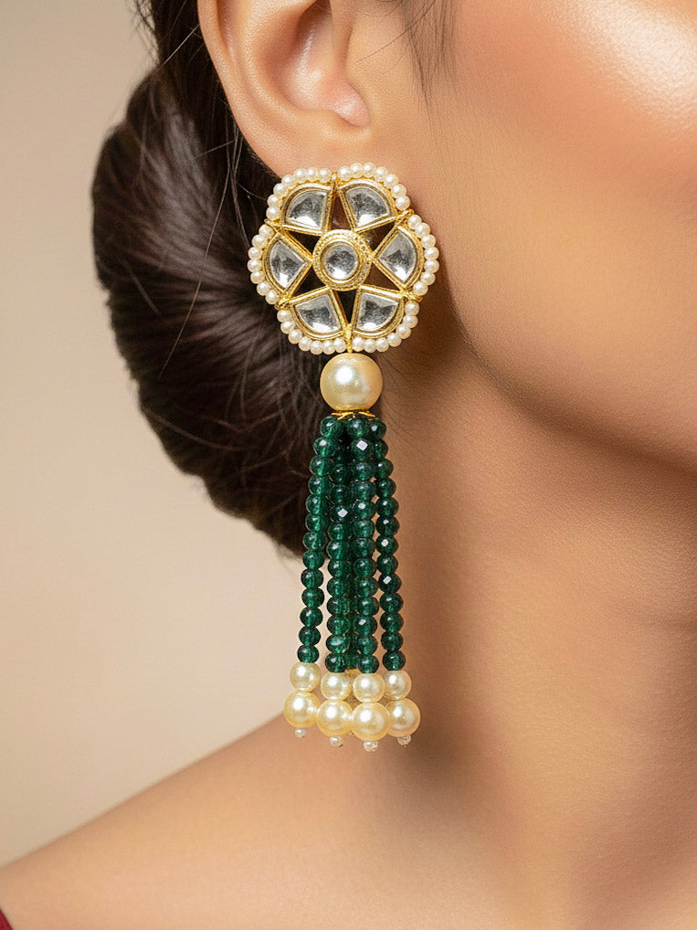 Close-up of a woman wearing an ornate traditional Green Long jewellery set and earrings with Crystal Beads, Kundan and Pearls. Mehendi ceremony look completed with a handcrafted Kundan jewelry set. Festive saree styling with a premium artificial Kundan necklace.