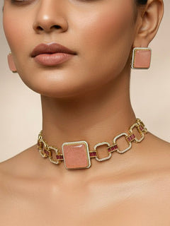 A beautiful woman wearing an elegant artificial diamond and peach colored stone choker necklace and matching earrings. This premium artificial diamond jewelry set is perfect for special occasions, from Indian weddings to engagement parties, offering sophisticated glamour without the high price tag.
