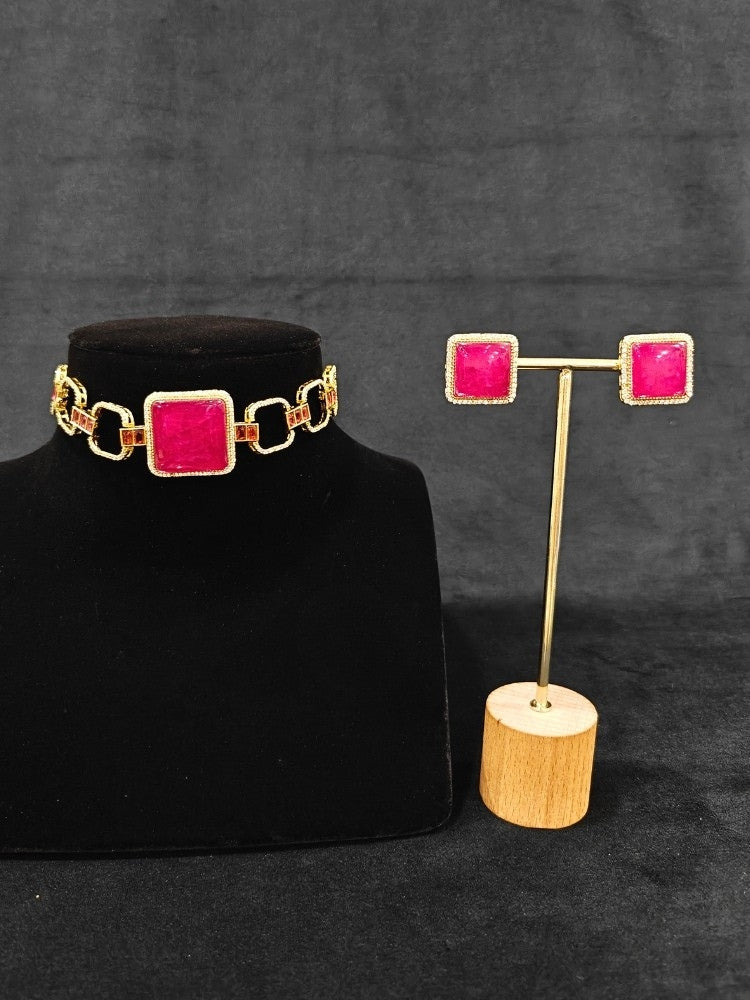 A luxurious artificial diamond and rani pink colored stone choker necklace with matching earrings, perfect for high-profile wedding receptions and formal galas. This high-end artificial diamond jewelry set combines style, elegance, and affordability for special occasions.