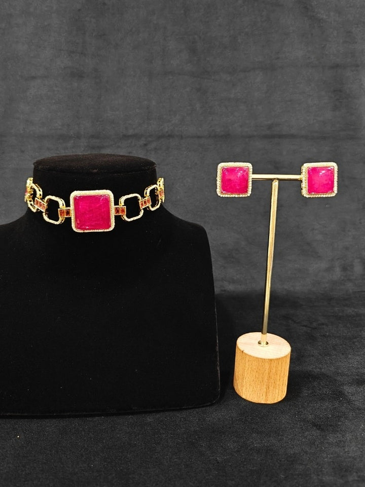 A luxurious artificial diamond and rani pink colored stone choker necklace with matching earrings, perfect for high-profile wedding receptions and formal galas. This high-end artificial diamond jewelry set combines style, elegance, and affordability for special occasions.