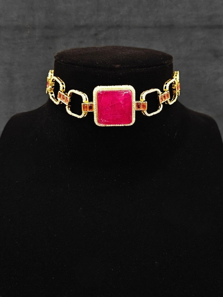 A luxurious artificial diamond and rani pink colored stone choker necklace with matching earrings, perfect for high-profile wedding receptions and formal galas. This high-end artificial diamond jewelry set combines style, elegance, and affordability for special occasions.