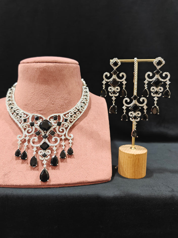Close-up of an ornate Black Indo-Western Diamond Silver Collar jewellery set and earrings and maangtikka with American Diamond and Black Colored Stones. Bride-to-be styled in a premium American diamond artificial necklace for her reception party. Elegant wedding jewelry look featuring a premium artificial American diamond necklace.