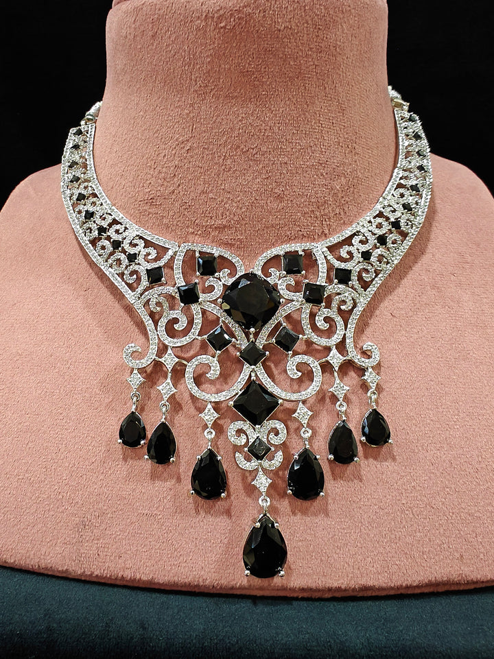 Close-up of an ornate Black Indo-Western Diamond Silver Collar jewellery set and earrings and maangtikka with American Diamond and Black Colored Stones. Bride-to-be styled in a premium American diamond artificial necklace for her reception party. Elegant wedding jewelry look featuring a premium artificial American diamond necklace.