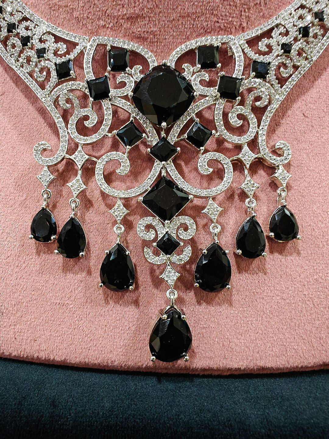 Close-up of an ornate Black Indo-Western Diamond Silver Collar jewellery set and earrings and maangtikka with American Diamond and Black Colored Stones. Bride-to-be styled in a premium American diamond artificial necklace for her reception party. Elegant wedding jewelry look featuring a premium artificial American diamond necklace.