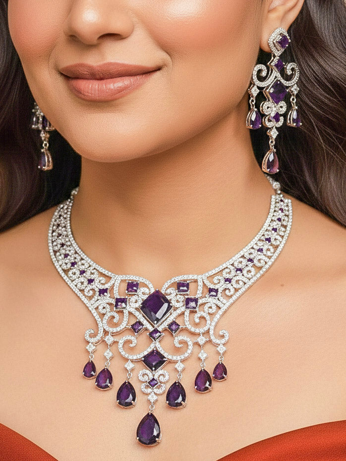 Close-up of a woman wearing an ornate Indo-Western American Diamond Silver Collar jewellery set and earrings and maangtikka with American Diamond and Purple Colored Stones. Bride-to-be styled in a premium American diamond artificial necklace for her reception party. Elegant wedding jewelry look featuring a premium artificial American diamond necklace.