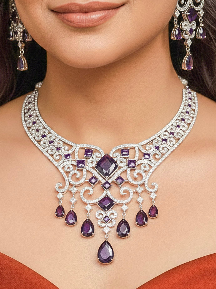 Close-up of a woman wearing an ornate Indo-Western American Diamond Silver Collar jewellery set and earrings and maangtikka with American Diamond and Purple Colored Stones. Bride-to-be styled in a premium American diamond artificial necklace for her reception party. Elegant wedding jewelry look featuring a premium artificial American diamond necklace.