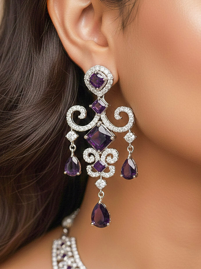 Close-up of a woman wearing an ornate Indo-Western American Diamond Silver Collar jewellery set and earrings and maangtikka with American Diamond and Purple Colored Stones. Bride-to-be styled in a premium American diamond artificial necklace for her reception party. Elegant wedding jewelry look featuring a premium artificial American diamond necklace.