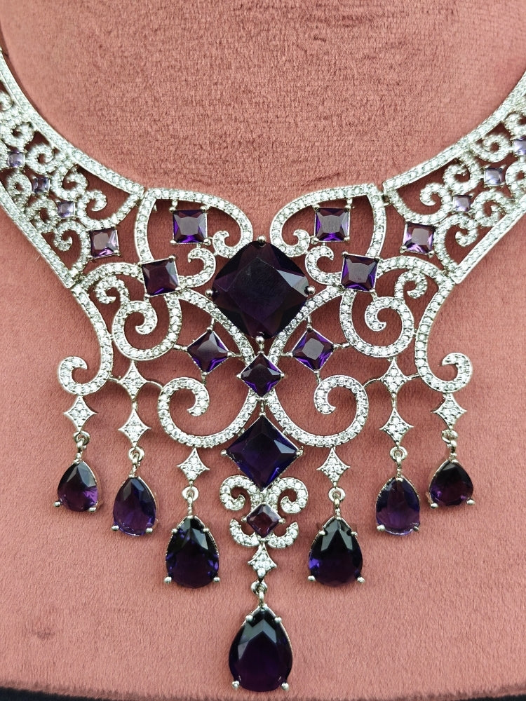 Close-up of an ornate Indo-Western American Diamond Silver Collar jewellery set and earrings and maangtikka with American Diamond and Purple Colored Stones. Bride-to-be styled in a premium American diamond artificial necklace for her reception party. Elegant wedding jewelry look featuring a premium artificial American diamond necklace.