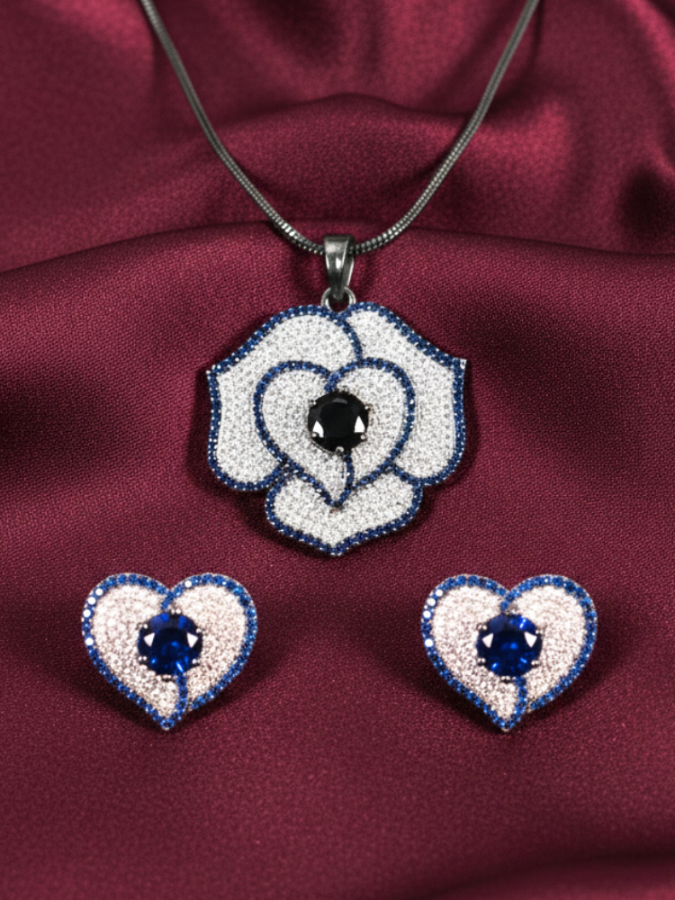 Close-up of an ornate Western Blue (Black Polish Victorian Finish) Pendant set and earrings with American Diamond and Blue Colored Stones. Close-up shot of a high-quality American diamond artificial Pendant worn for festive celebrations. Party wear outfit completed with a lightweight American diamond Pendant.
