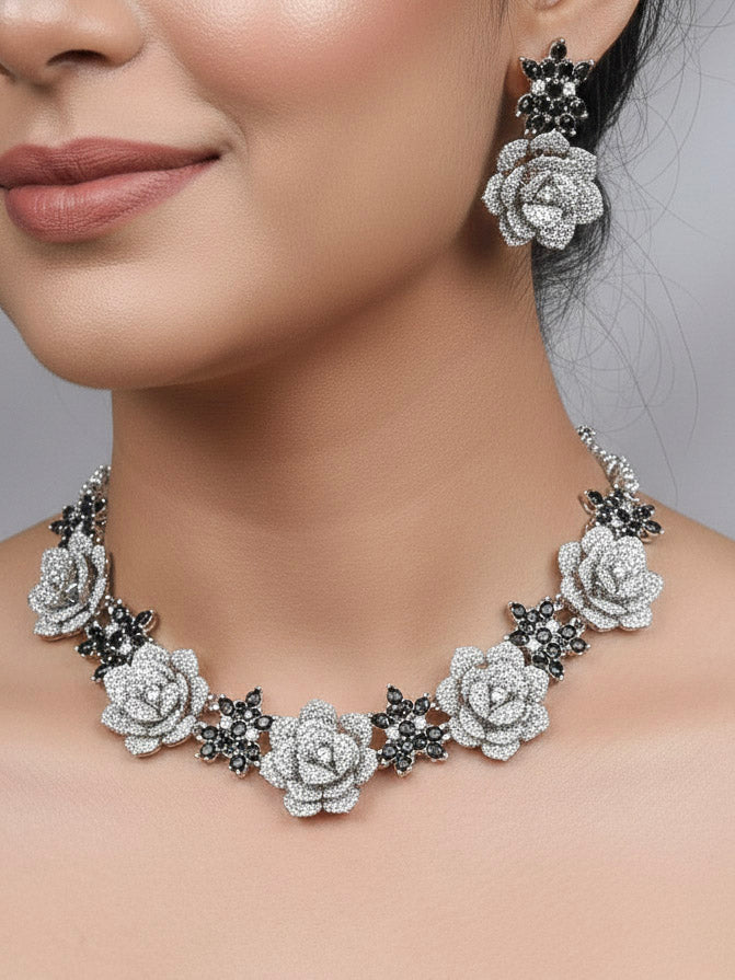 Close-up of a woman wearing an ornate  Indo-western Black Silver Collar American Diamond jewellery set, earrings, maangtikka, Ring and Bracelet with Black Colored Stones and American Diamond. Woman styling a statement American diamond necklace with an off-shoulder gown for a reception. A graceful woman wearing a trending American diamond necklace for a 2026 wedding celebration.