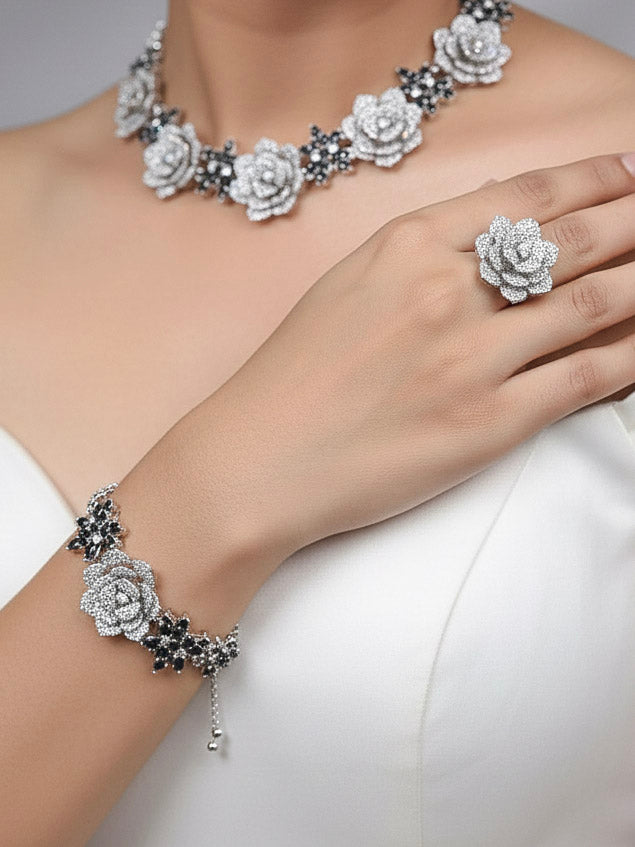 Close-up of a woman wearing an ornate  Indo-western Black Silver Collar American Diamond jewellery set, earrings, maangtikka, Ring and Bracelet with Black Colored Stones and American Diamond. Woman styling a statement American diamond necklace with an off-shoulder gown for a reception. A graceful woman wearing a trending American diamond necklace for a 2026 wedding celebration.