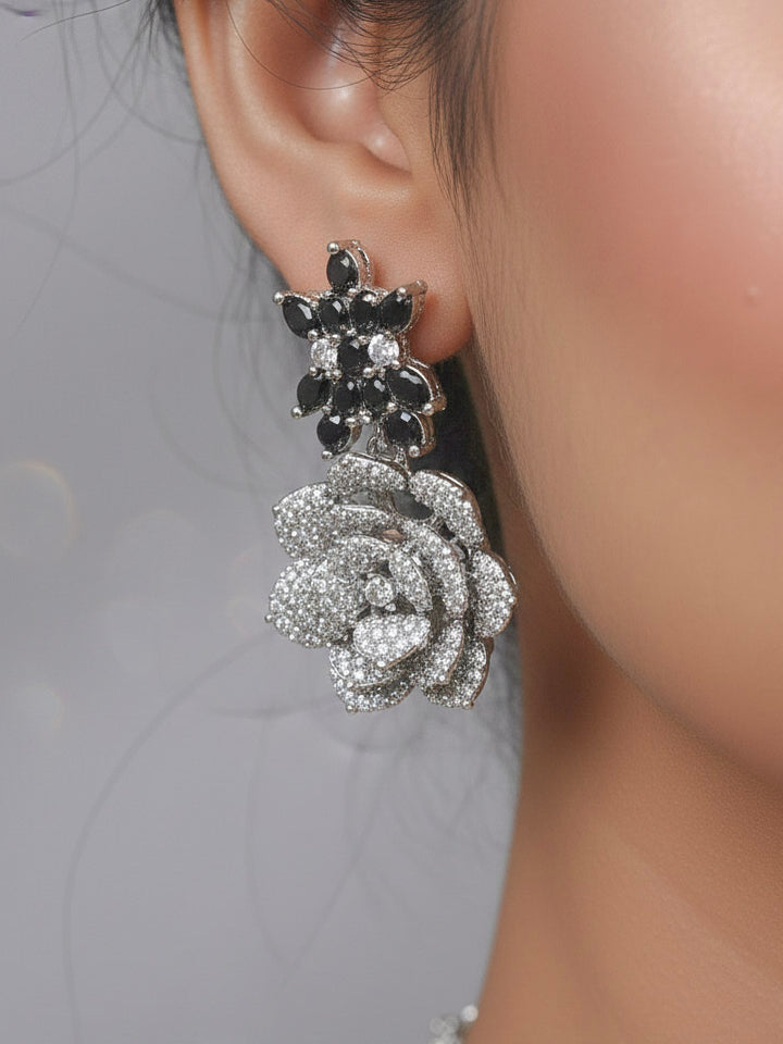 Close-up of a woman wearing an ornate  Indo-western Black Silver Collar American Diamond jewellery set, earrings, maangtikka, Ring and Bracelet with Black Colored Stones and American Diamond. Woman styling a statement American diamond necklace with an off-shoulder gown for a reception. A graceful woman wearing a trending American diamond necklace for a 2026 wedding celebration.
