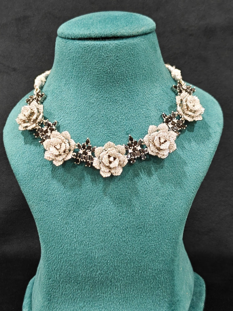Close-up of an ornate  Indo-western Black Silver Collar American Diamond jewellery set, earrings, maangtikka, Ring and Bracelet with Black Colored Stones and American Diamond. A graceful trending American diamond necklace for a 2026 wedding celebration.