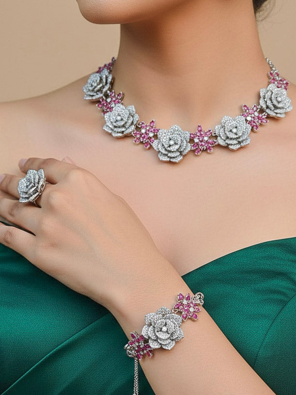 Close-up of a woman wearing an ornate  Indo-western Pink Silver Collar American Diamond jewellery set, earrings, maangtikka, Ring and Bracelet with Pink Colored Stones and American Diamond. Woman styling a statement American diamond necklace with an off-shoulder gown for a reception. A graceful woman wearing a trending American diamond necklace for a 2026 wedding celebration.
