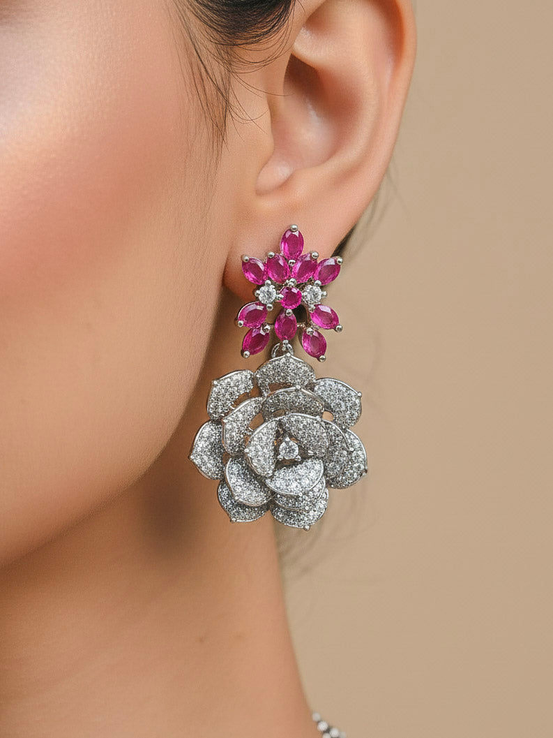 Close-up of a woman wearing an ornate  Indo-western Pink Silver Collar American Diamond jewellery set, earrings, maangtikka, Ring and Bracelet with Pink Colored Stones and American Diamond. Woman styling a statement American diamond necklace with an off-shoulder gown for a reception. A graceful woman wearing a trending American diamond necklace for a 2026 wedding celebration.