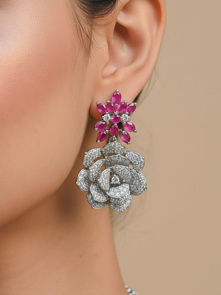 Close-up of a woman wearing an ornate  Indo-western Pink Silver Collar American Diamond jewellery set, earrings, maangtikka, Ring and Bracelet with Pink Colored Stones and American Diamond. Woman styling a statement American diamond necklace with an off-shoulder gown for a reception. A graceful woman wearing a trending American diamond necklace for a 2026 wedding celebration.