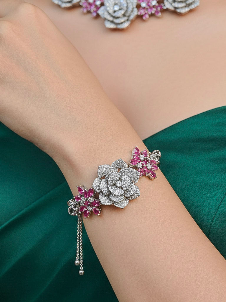 Close-up of a woman wearing an ornate  Indo-western Pink Silver Collar American Diamond jewellery set, earrings, maangtikka, Ring and Bracelet with Pink Colored Stones and American Diamond. Woman styling a statement American diamond necklace with an off-shoulder gown for a reception. A graceful woman wearing a trending American diamond necklace for a 2026 wedding celebration.