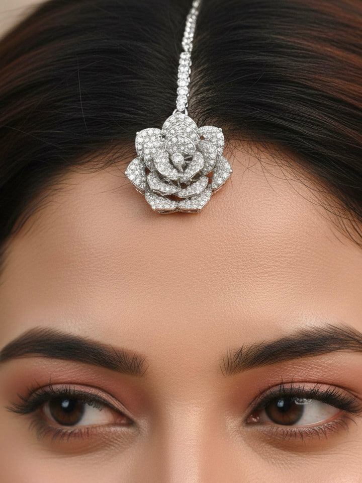 Close-up of a woman wearing an ornate  Indo-western Pink Silver Collar American Diamond jewellery set, earrings, maangtikka, Ring and Bracelet with Pink Colored Stones and American Diamond. Woman styling a statement American diamond necklace with an off-shoulder gown for a reception. A graceful woman wearing a trending American diamond necklace for a 2026 wedding celebration.