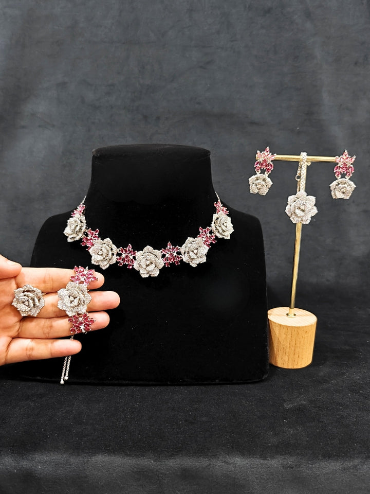 Close-up of an ornate Indo-western Pink Silver Collar American Diamond jewellery set, earrings, maangtikka, Ring and Bracelet with Pink Colored Stones and American Diamond. A graceful trending American diamond necklace for a 2026 wedding celebration.