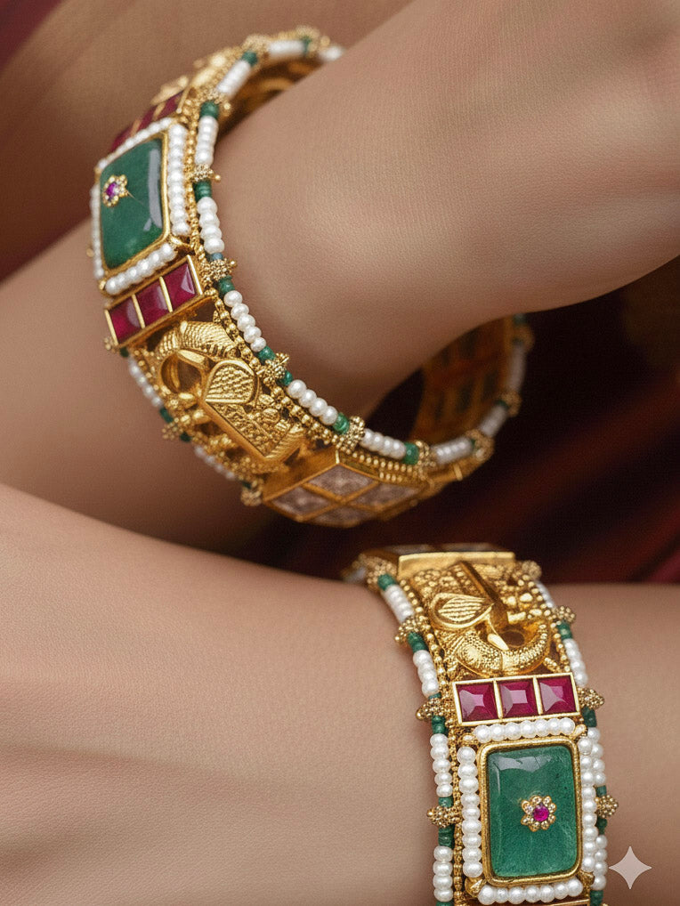 Close-up of a woman wearing an ornate traditional (Gold Polish) Mint Green Bangles set with Colored Stones, Pearl and Polki. Woman stacking artificial Colored Stone bangles for a festive Diwali celebration. Saree styling inspiration featuring traditional imitation Colored Stone bangles.
