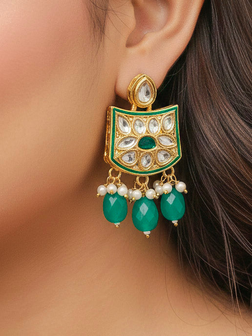 Close-up of a woman wearing an ornate traditional (Gold Polish) Dark Green Choker jewellery set and earrings with Pearl, Crystal stones, Kundan, Colored Stones and Tumble Beads. Mehendi ceremony look completed with a handcrafted Kundan jewelry set. Wedding celebration look enhanced with a statement Kundan necklace.