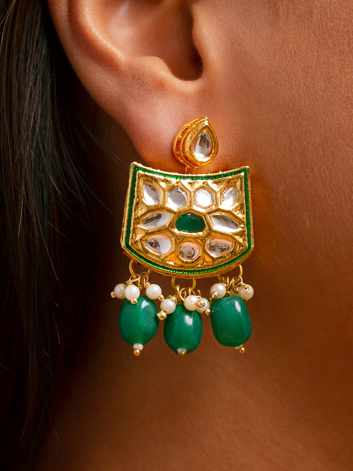 Close-up of a woman wearing an ornate traditional (Gold Polish) Dark Green Choker jewellery set and earrings with Pearl, Crystal stones, Kundan, Colored Stones and Tumble Beads. Mehendi ceremony look completed with a handcrafted Kundan jewelry set. Wedding celebration look enhanced with a statement Kundan necklace.