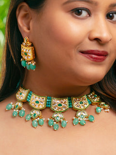 Close-up of a woman wearing an ornate traditional (Gold Polish) Mint Green Choker jewellery set and earrings with Pearl, Crystal stones, Kundan, Colored Stones and Tumble Beads. Mehendi ceremony look completed with a handcrafted Kundan jewelry set. Wedding celebration look enhanced with a statement Kundan necklace.