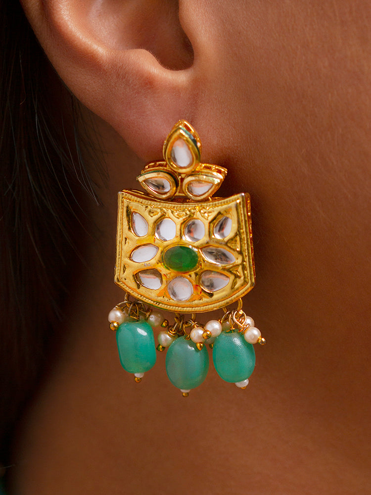 Close-up of a woman wearing an ornate traditional (Gold Polish) Mint Green Choker jewellery set and earrings with Pearl, Crystal stones, Kundan, Colored Stones and Tumble Beads. Mehendi ceremony look completed with a handcrafted Kundan jewelry set. Wedding celebration look enhanced with a statement Kundan necklace.