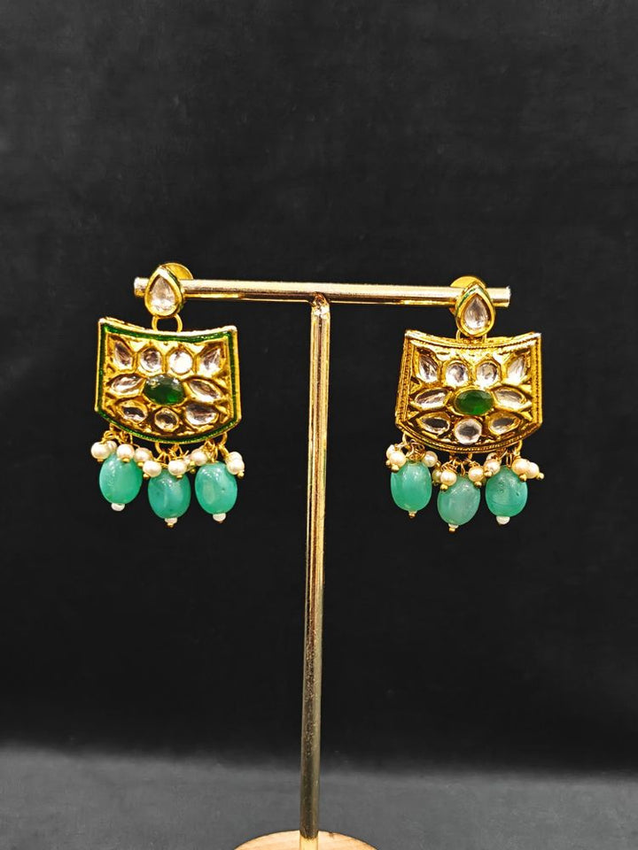 Close-up of an ornate traditional (Gold Polish) Mint Green Choker jewellery set and earrings with Pearl, Crystal stones, Kundan, Colored Stones and Tumble Beads. Mehendi ceremony look completed with a handcrafted Kundan jewelry set. Wedding celebration look enhanced with a statement Kundan necklace.