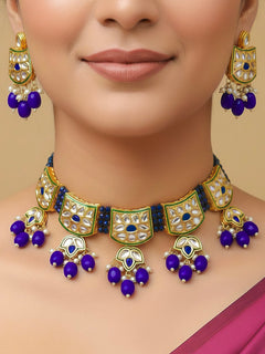 Close-up of a woman wearing an ornate traditional (Gold Polish) Purple Choker jewellery set and earrings with Pearl, Crystal stones, Kundan, Colored Stones and Tumble Beads. Mehendi ceremony look completed with a handcrafted Kundan jewelry set. Wedding celebration look enhanced with a statement Kundan necklace.