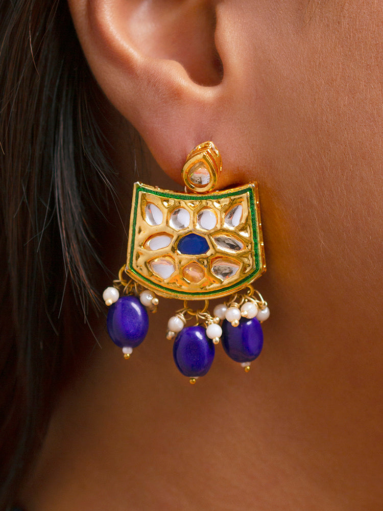 Close-up of a woman wearing an ornate traditional (Gold Polish) Purple Choker jewellery set and earrings with Pearl, Crystal stones, Kundan, Colored Stones and Tumble Beads. Mehendi ceremony look completed with a handcrafted Kundan jewelry set. Wedding celebration look enhanced with a statement Kundan necklace.