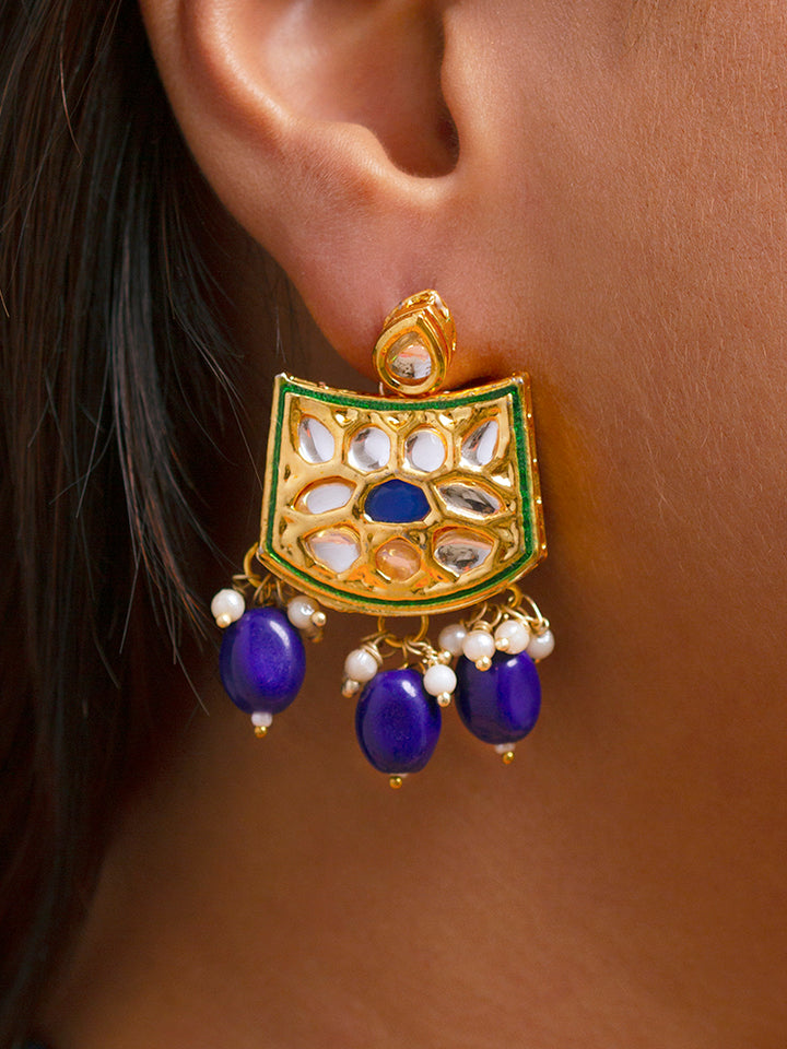 Close-up of a woman wearing an ornate traditional (Gold Polish) Purple Choker jewellery set and earrings with Pearl, Crystal stones, Kundan, Colored Stones and Tumble Beads. Mehendi ceremony look completed with a handcrafted Kundan jewelry set. Wedding celebration look enhanced with a statement Kundan necklace.