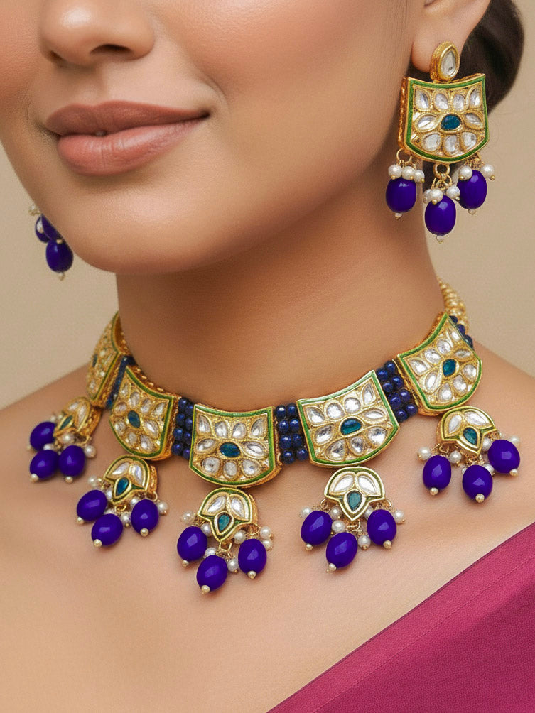 Close-up of a woman wearing an ornate traditional (Gold Polish) Purple Choker jewellery set and earrings with Pearl, Crystal stones, Kundan, Colored Stones and Tumble Beads. Mehendi ceremony look completed with a handcrafted Kundan jewelry set. Wedding celebration look enhanced with a statement Kundan necklace.