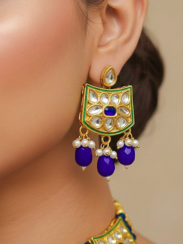 Close-up of a woman wearing an ornate traditional (Gold Polish) Purple Choker jewellery set and earrings with Pearl, Crystal stones, Kundan, Colored Stones and Tumble Beads. Mehendi ceremony look completed with a handcrafted Kundan jewelry set. Wedding celebration look enhanced with a statement Kundan necklace.