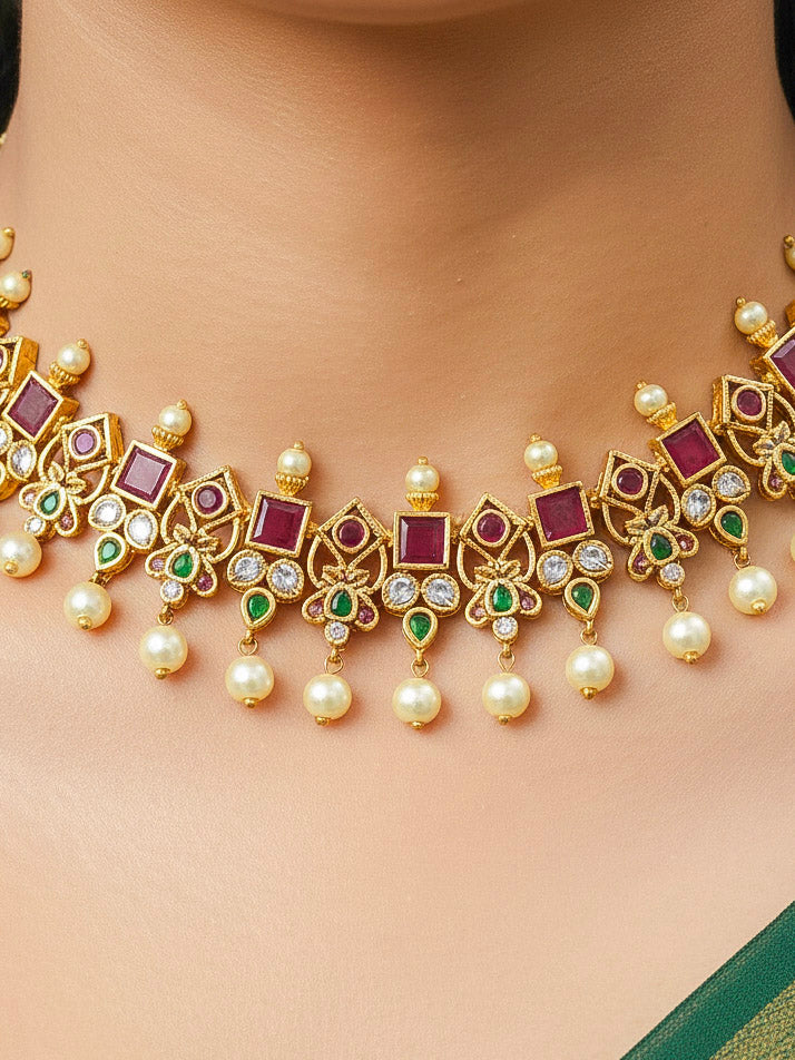 Close-up of a woman wearing an ornate traditional (Gold Polish) Pink jewellery set and earrings with Pearls and Colored Stones. Festive saree styling with a premium artificial Colored Stones necklace. Mehendi ceremony look completed with a handcrafted Colored Stones jewelry set.