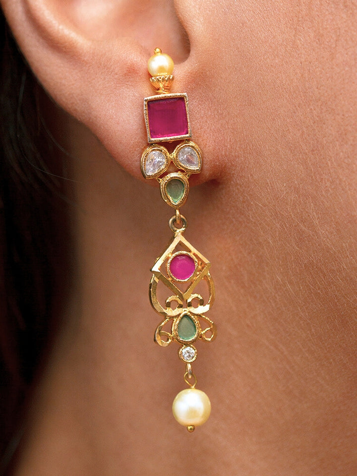 Close-up of a woman wearing an ornate traditional (Gold Polish) Pink jewellery set and earrings with Pearls and Colored Stones. Festive saree styling with a premium artificial Colored Stones necklace. Mehendi ceremony look completed with a handcrafted Colored Stones jewelry set.
