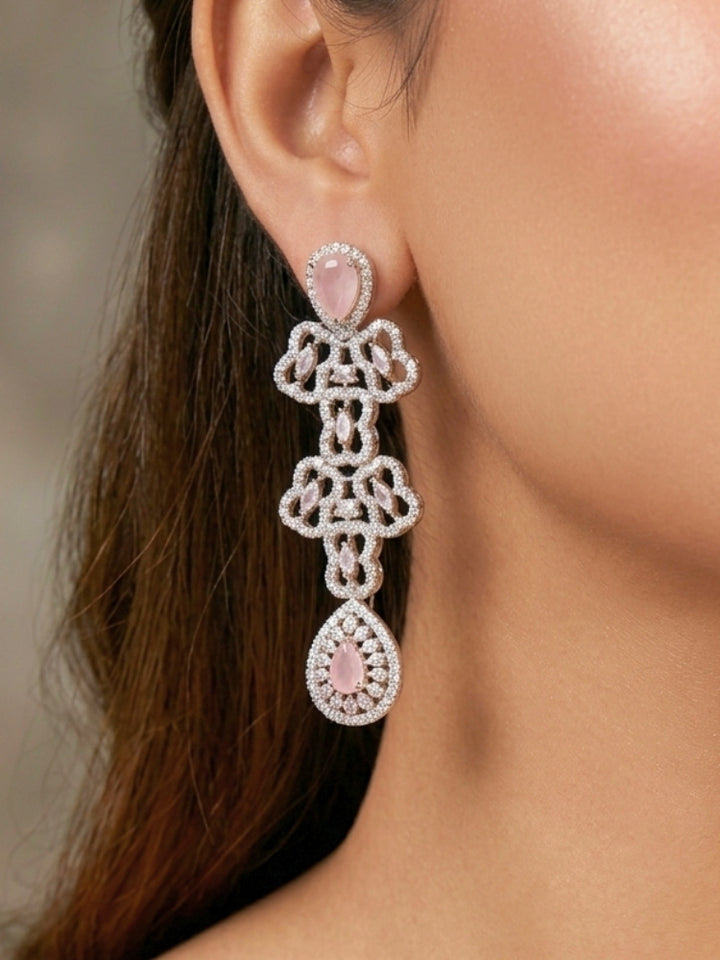 Close-up of a women wearing an ornate Western (Silver Polish) Collar Layered jewellery set and earrings with American Diamond and Mint Pink Colored Stones. Reception-ready look featuring a statement American diamond jewelry set. Elegant wedding jewelry look featuring a premium artificial American diamond necklace.