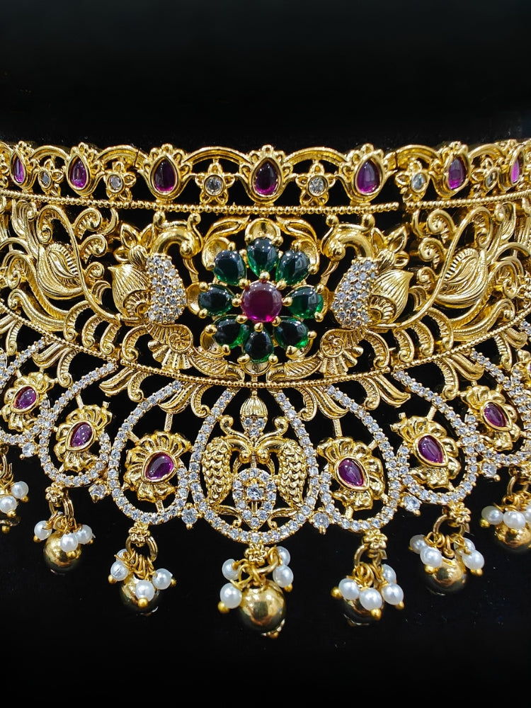 Close-up of an ornate traditional Heritage gold Choker jewellery set and earrings with Pota Stone and American Diamond. Wedding guest look featuring a traditional heritage artificial necklace. Close-up of antique-style detailing in heritage artificial jewelry.
