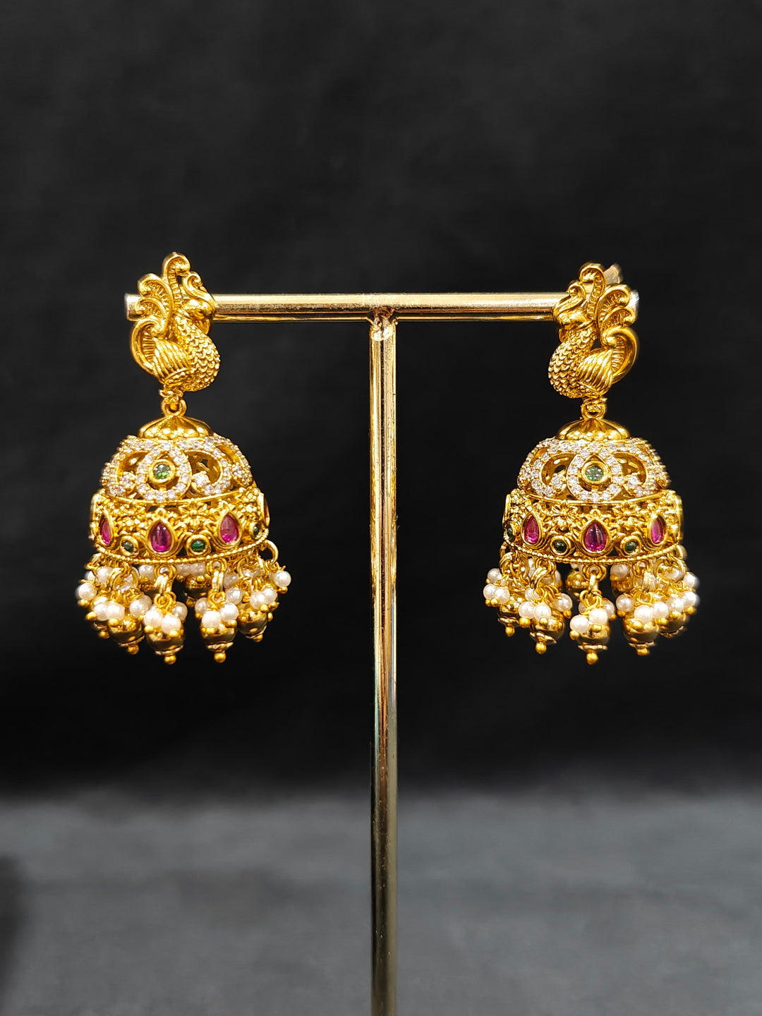 Close-up of an ornate traditional Heritage gold Choker jewellery set and earrings with Pota Stone and American Diamond. Wedding guest look featuring a traditional heritage artificial necklace. Close-up of antique-style detailing in heritage artificial jewelry.