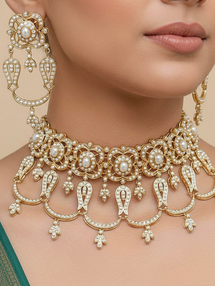 Close-up of a woman wearing an ornate traditional Choker white jadau gold jewellery set and jadau earrings with Pearl. Festive celebration look featuring a Jadau artificial necklace. Woman pairing a traditional Jadau necklace with a silk saree and Lehenga.